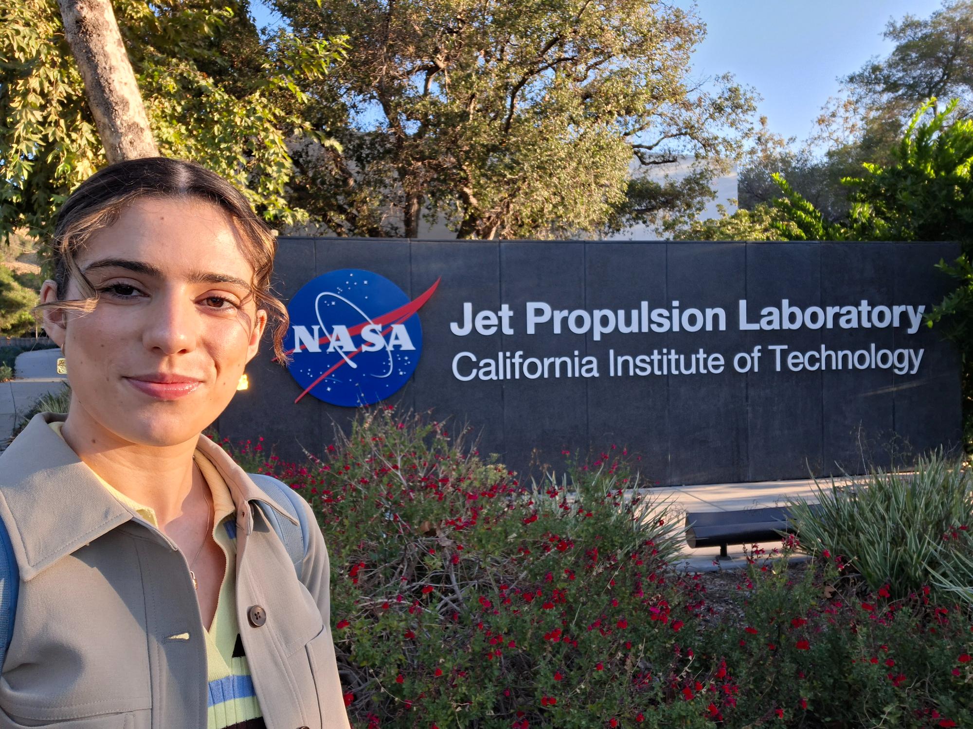 Jaimie Duffy in front of the NASA JPL sign