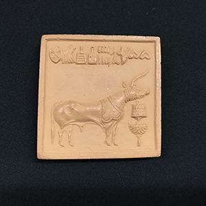 Square terracotta stamp with agricultural scene 