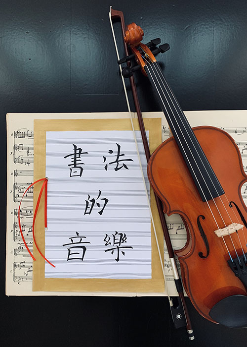 Mixed media artwork featuring a music sheet, violin and Chinese character writing