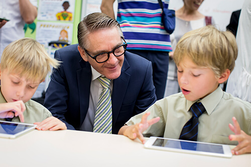 Some young students using iPads during the Korean teachers' visit 2014