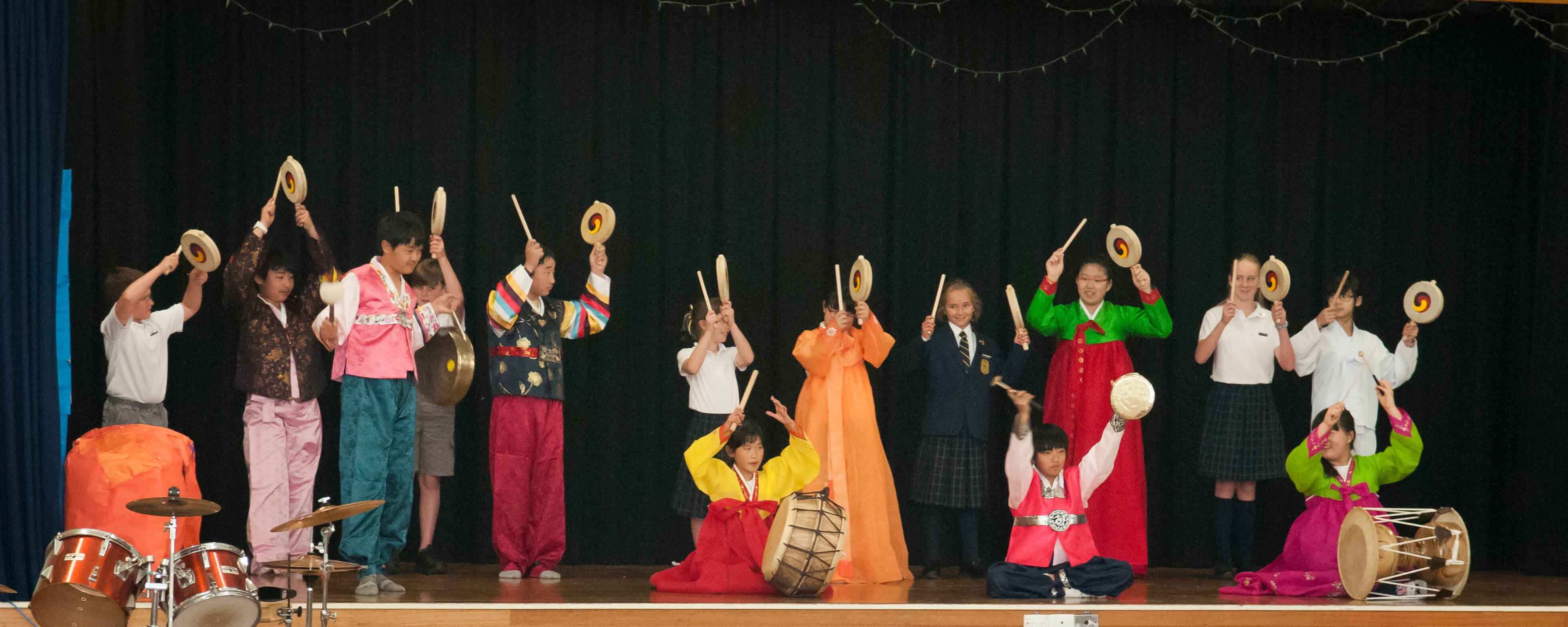AKC Students playing musical instruments on stage 