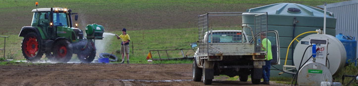 Farmers washing down machinery