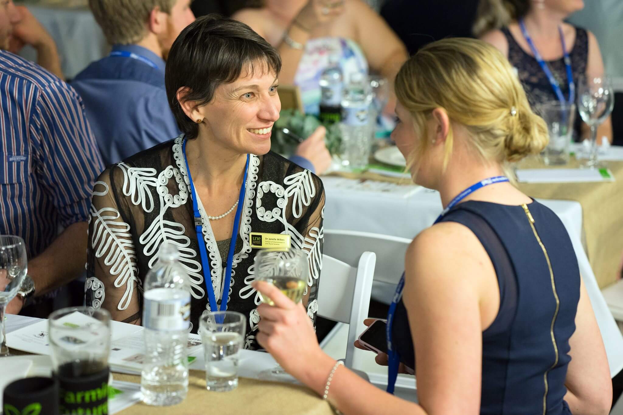 Two females in deep conversation at Farming Futures dinner