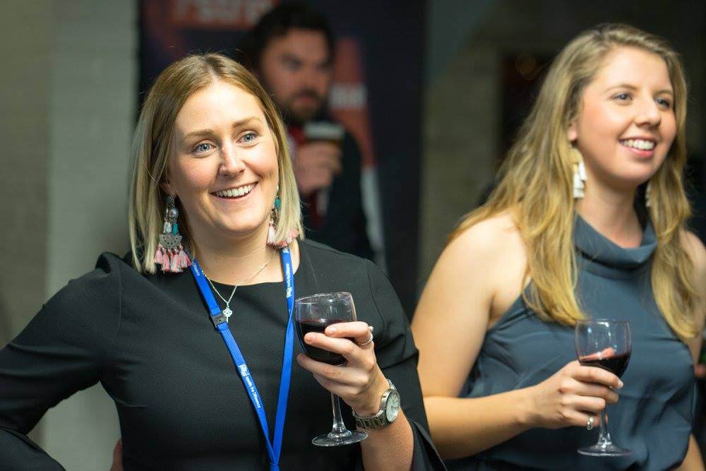 Two female students watching charity auction