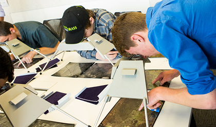 Four school students working.