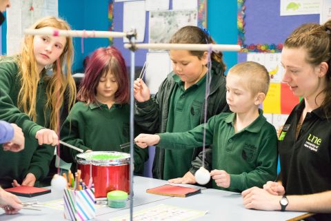 Primary School aged children performing science experiments with UNE Discovery