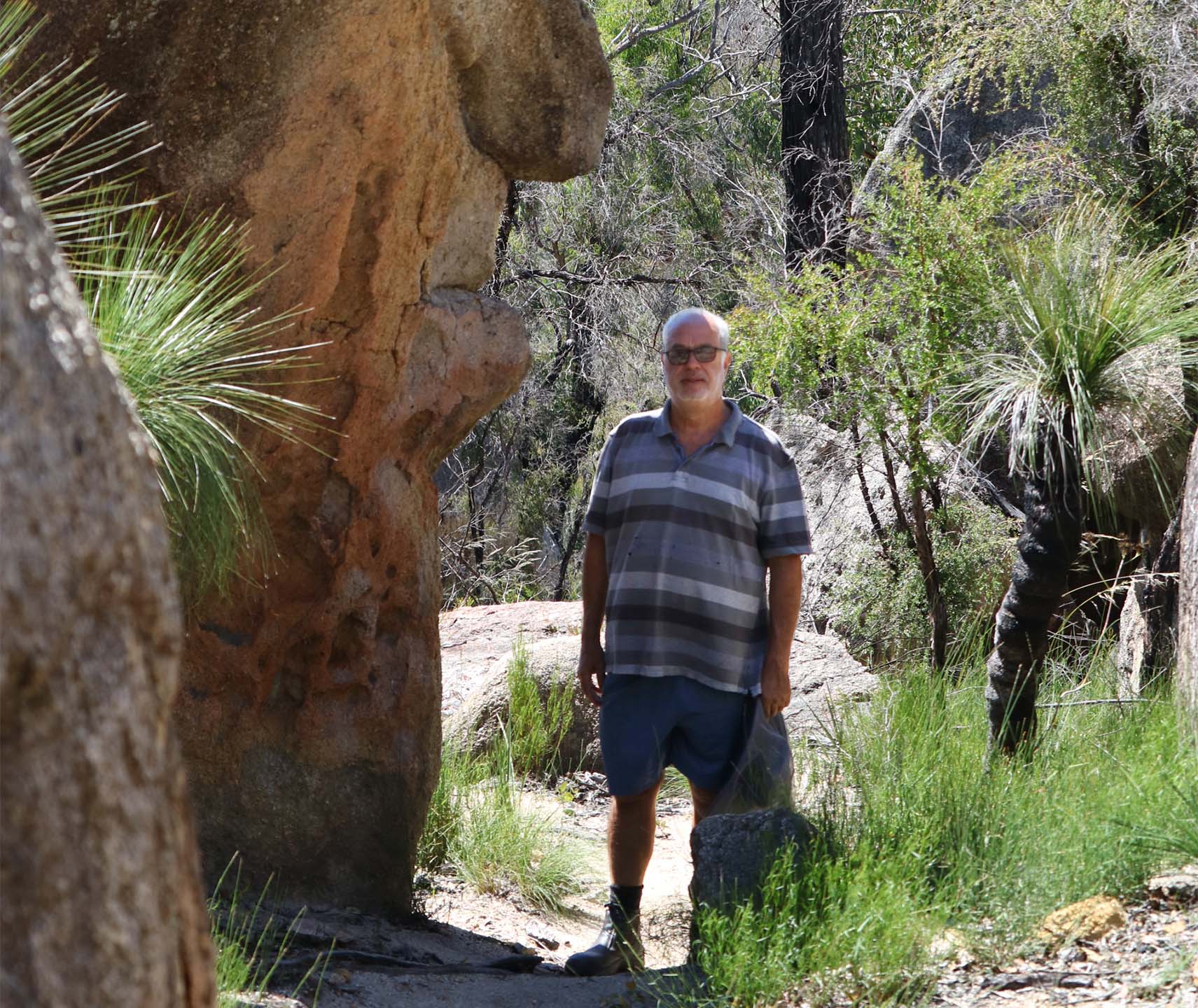 Paul Gordon standing next to a rock outcropping