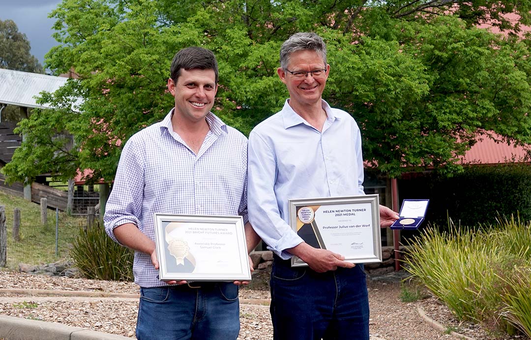 Left to right: Associate Professor Sam Clark and Professor Julius Van der Werf smiling at the camera holding their Helen Newton Turner awards