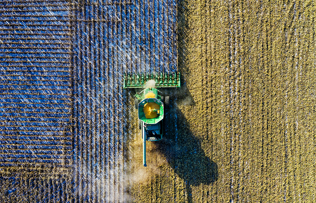 Aerial shot of a header in a paddock.