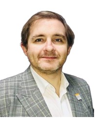 Profile picture of Dr Stafford Lumsden wearing a checkered grey jacket and white buttoned shirt