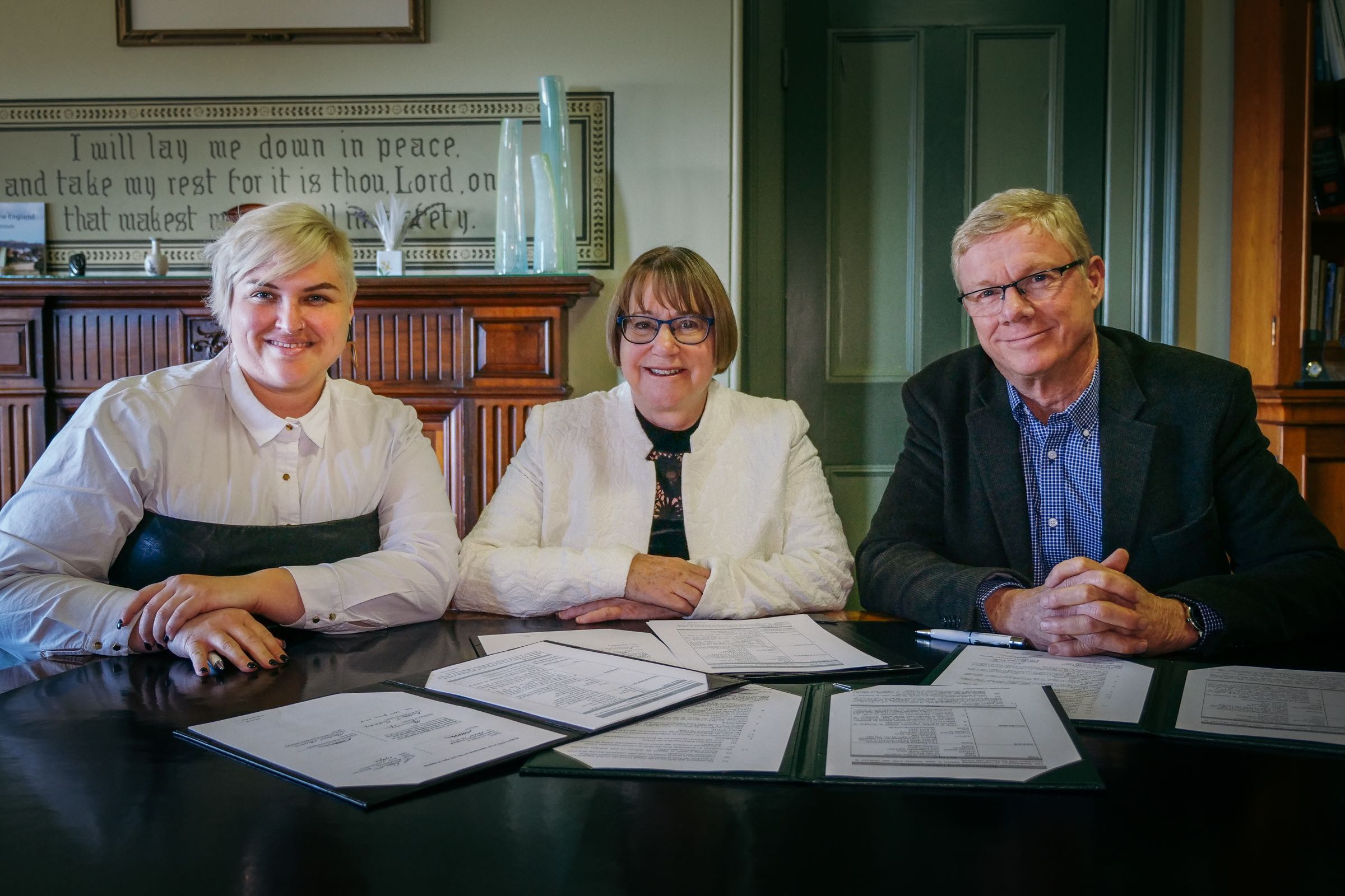 Rachel Parsons, Annabelle Duncan, and Andrew Murray sitting at table with signed papers