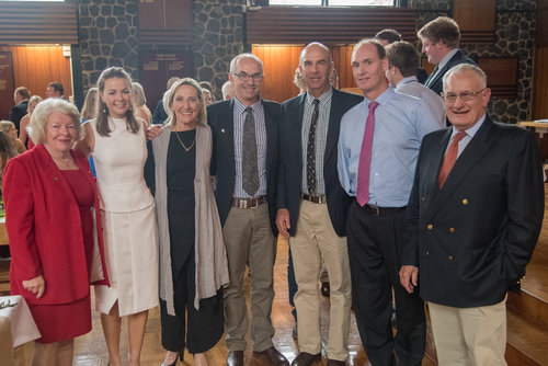 A group of men and women, mixed ages, at a Robb College evening event.