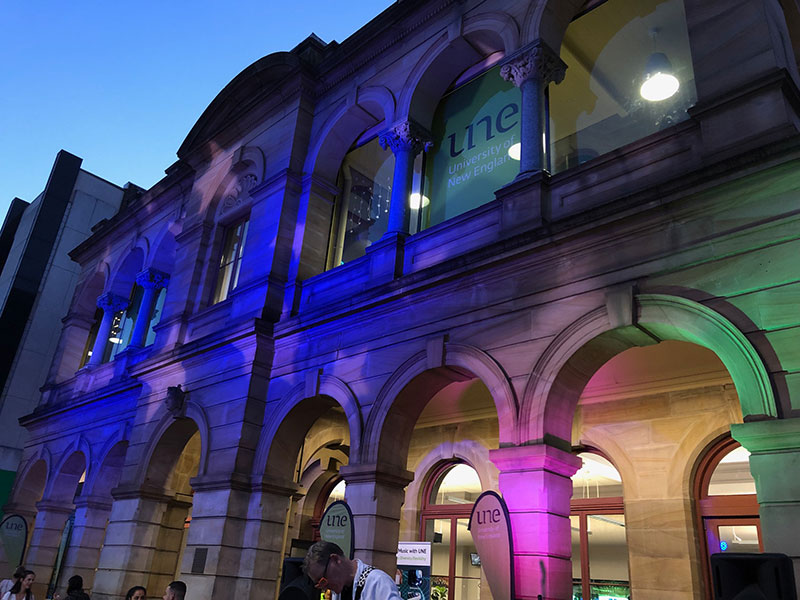 Coloured lights on the facade of UNE Sydney building.