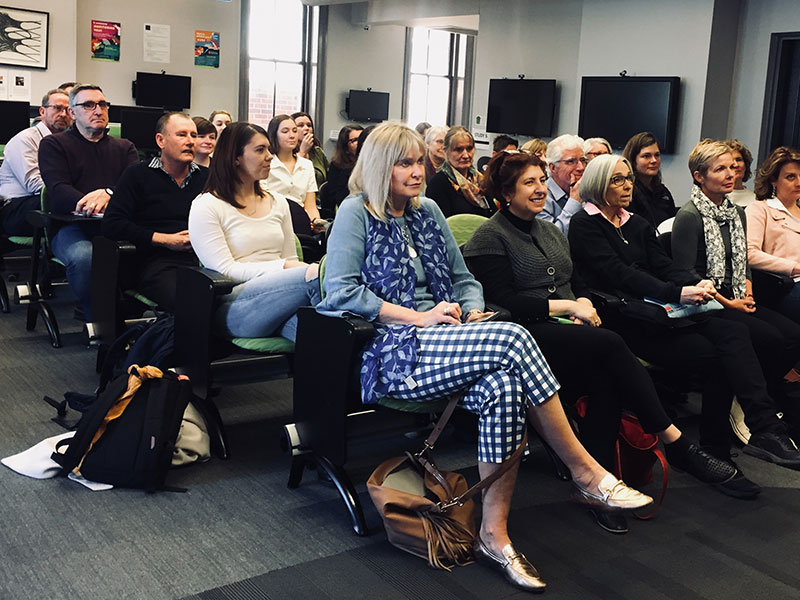 Seated audience at a lecture.