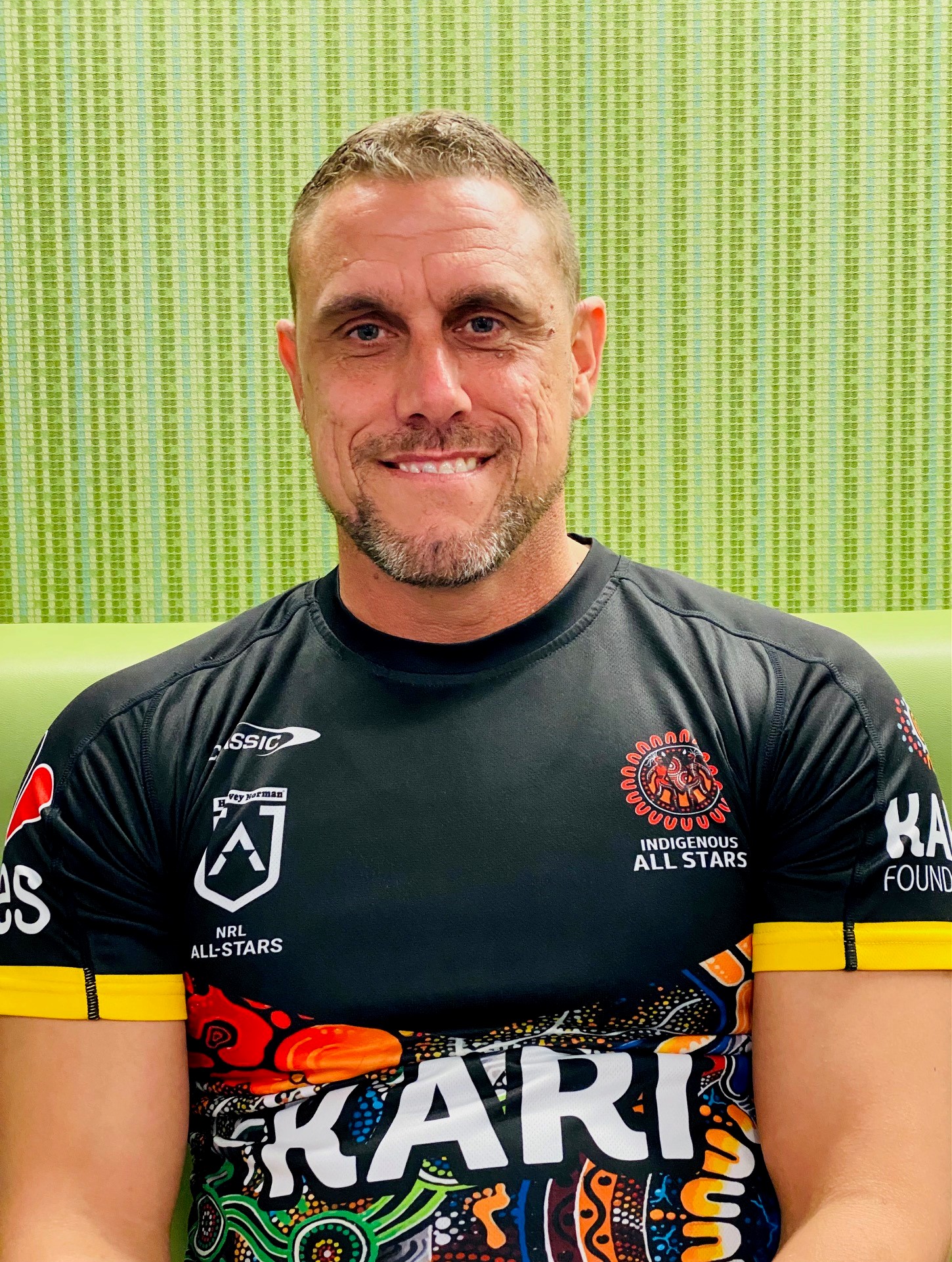 Jake, a proud Gomeroi/Ngemba man, graces the viewer with a grin.