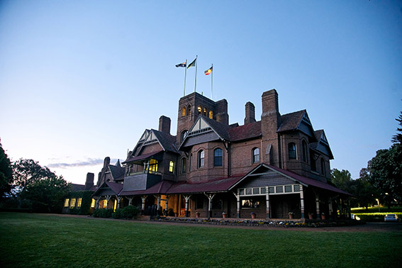 Booloominbah at sunset with flags raised