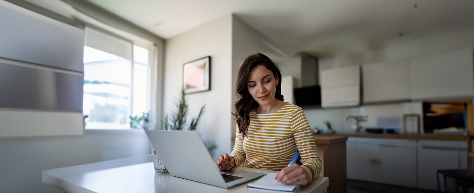 Woman working on laptop in living area