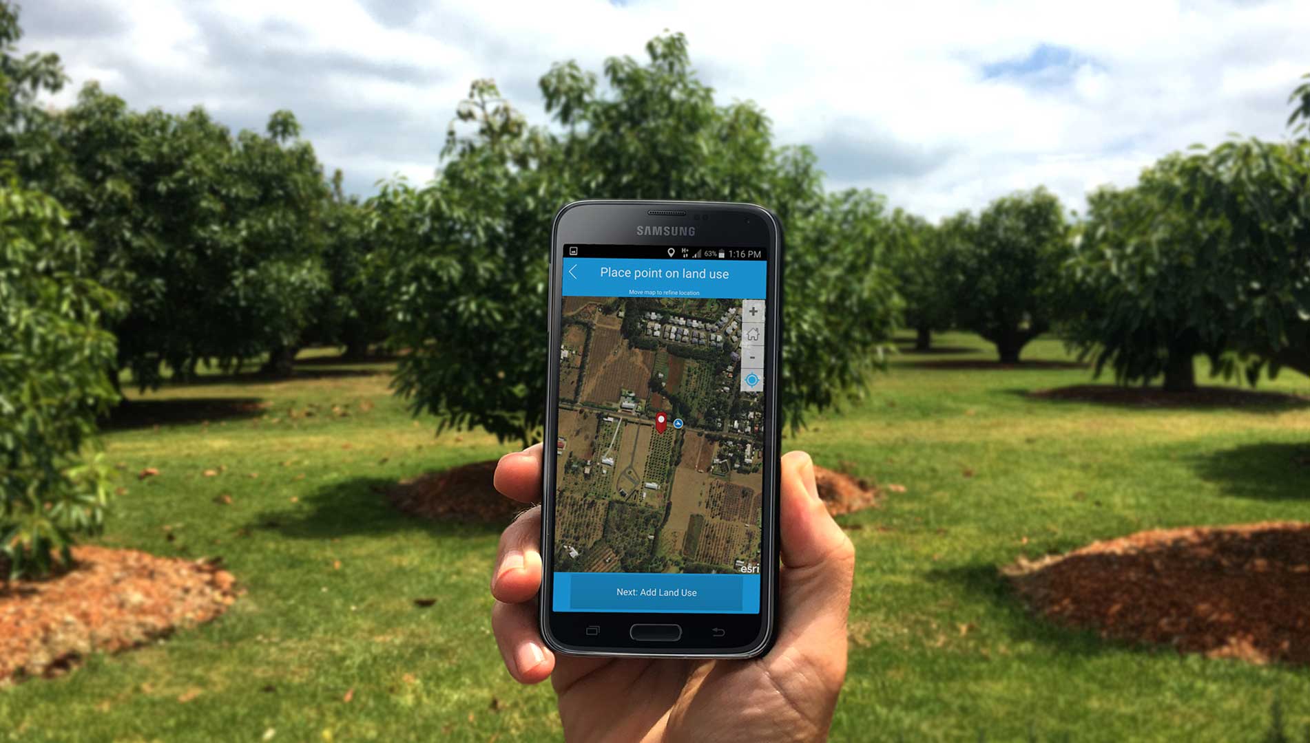 A hand holding a samsung phone whilst using the Land Use Survey App